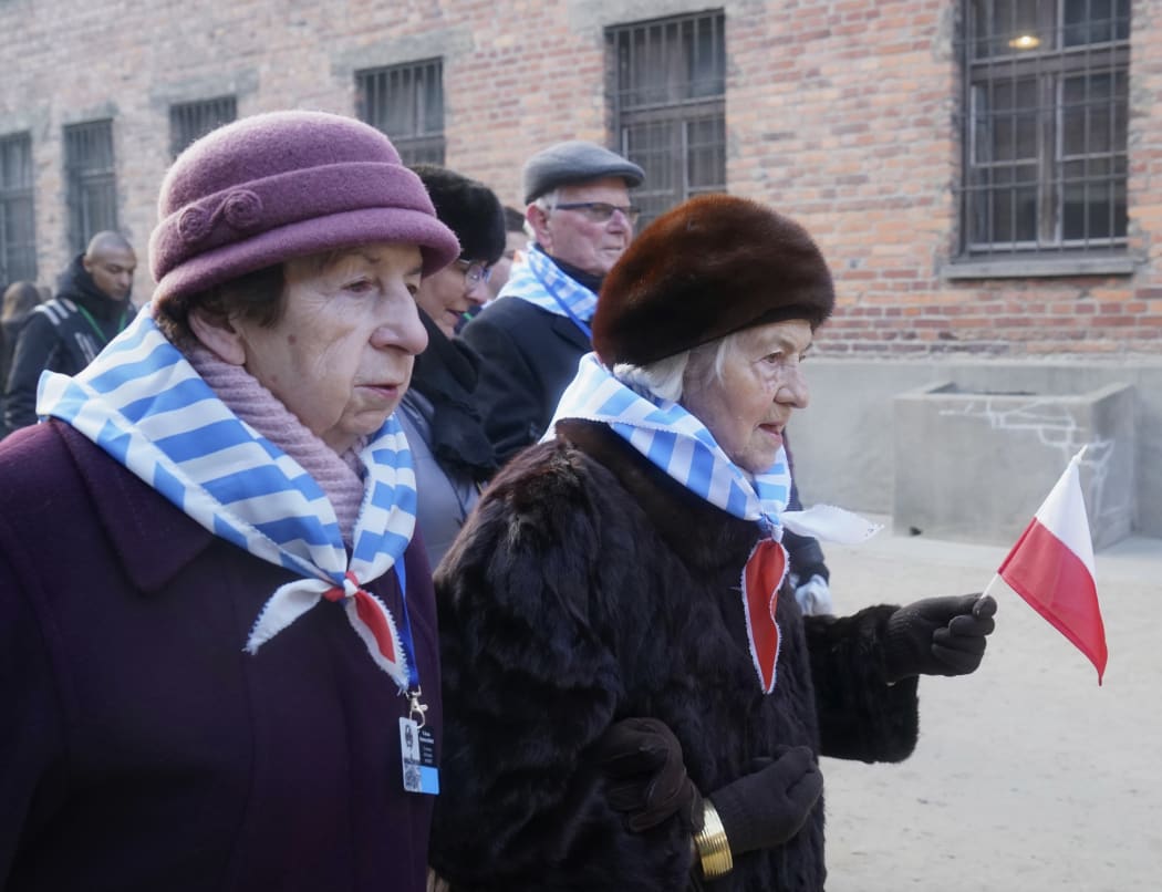 Holocaust survivors attend a wreath laying at the death wall at the memorial site of the former German Nazi death camp Auschwitz.