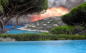 Smoke billows above Ramatuelle, southern France as a violent wildfire hit the area.