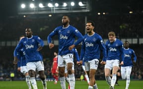 Everton striker Beto (2L) celebrates a goal against Liverpool.