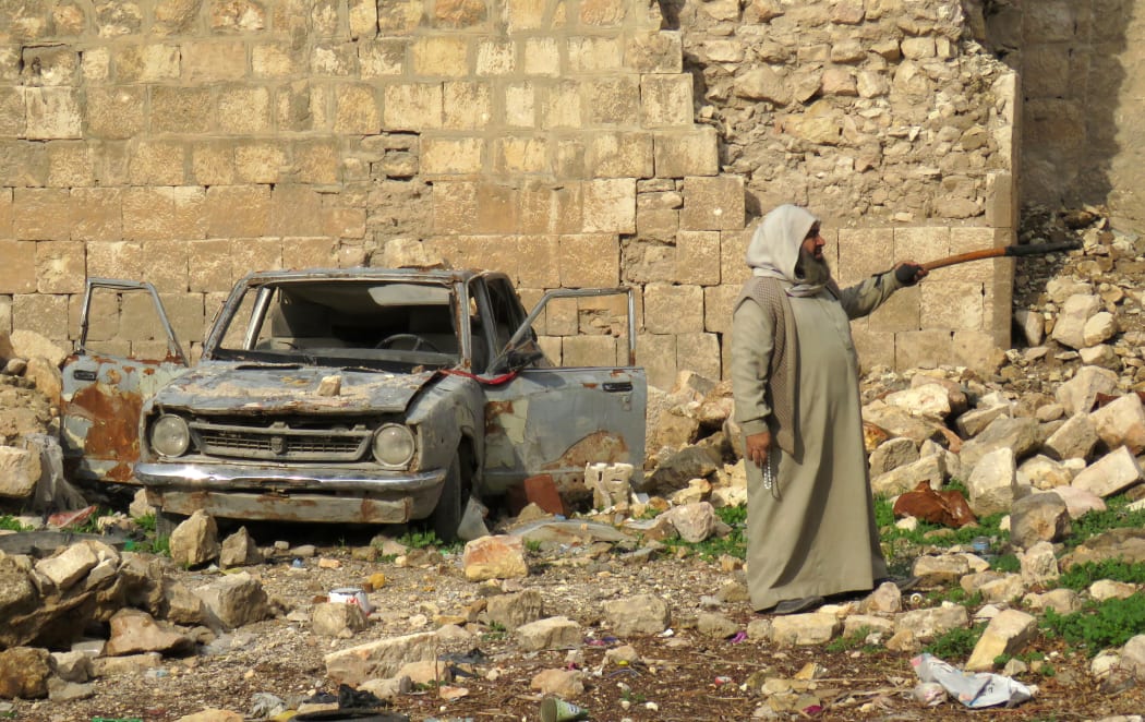 A Syrian man points at the destruction in the market in the government-held old city of Aleppo.