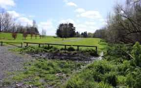 The muddy site where a burned out car was found with a body inside near Havelock North.