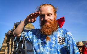 British runner Russ Cook gestures as he poses for a picture after his 16,000 km challenge to run across the African continent.