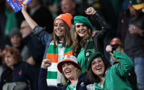 Ireland's supporters cheer in the stands ahead of the France 2023 Rugby World Cup quarter-final match between Ireland and New Zealand at the Stade de France in Saint-Denis, on the outskirts of Paris, on October 14, 2023. (Photo by FRANCK FIFE / AFP)