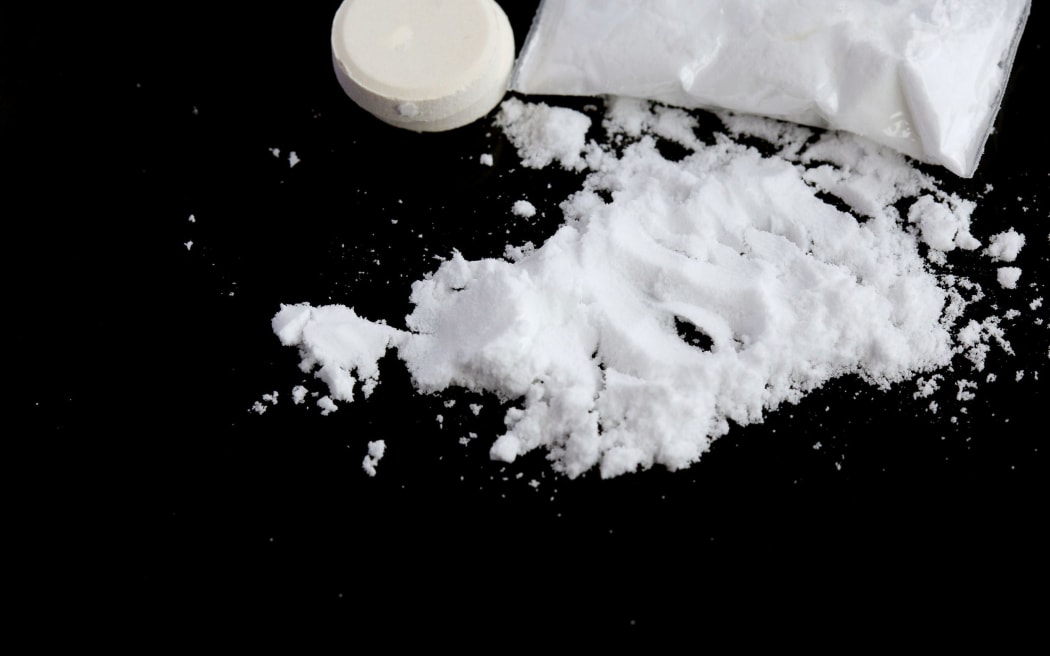 Drugs on a black surface.