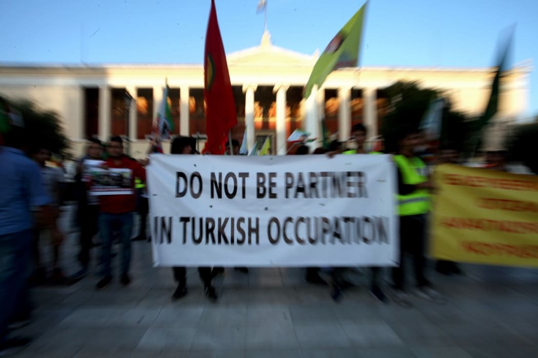 Kurds living in Athens protest near the Turkish Embassy against the Turkish offensive in northern Syria.