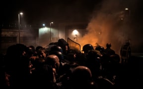 Striking prison guards clash with riot police in front of Villefranche-sur-Saone prison on Monday 22 January 2018.