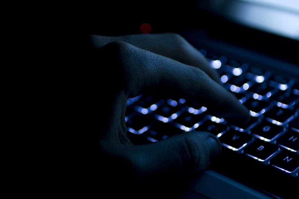 Hand on keyboard at night