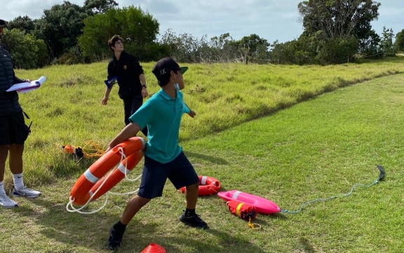Children practice thrown a rescue ring with Drowning Prevention Auckland.