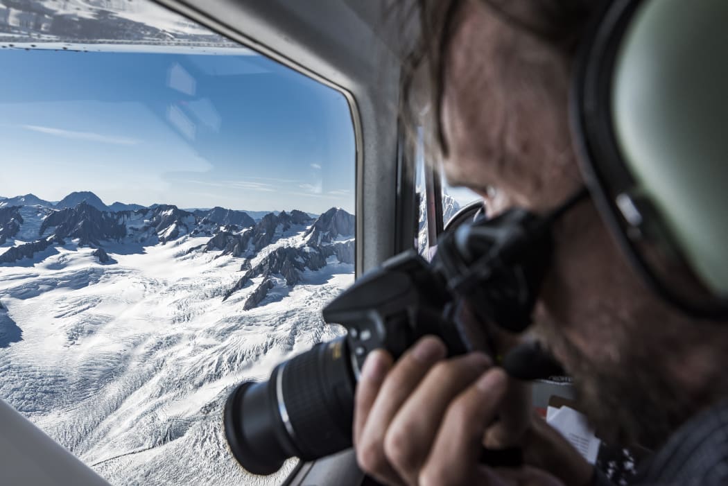 Brian Anderson photographs a glacier during the 2018 end of summer snowline survey.