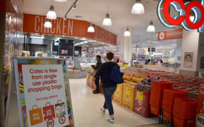 A sign, seen in a Coles supermarket, advises its customers of its plastic bag free in Sydney on July 2, 2018.