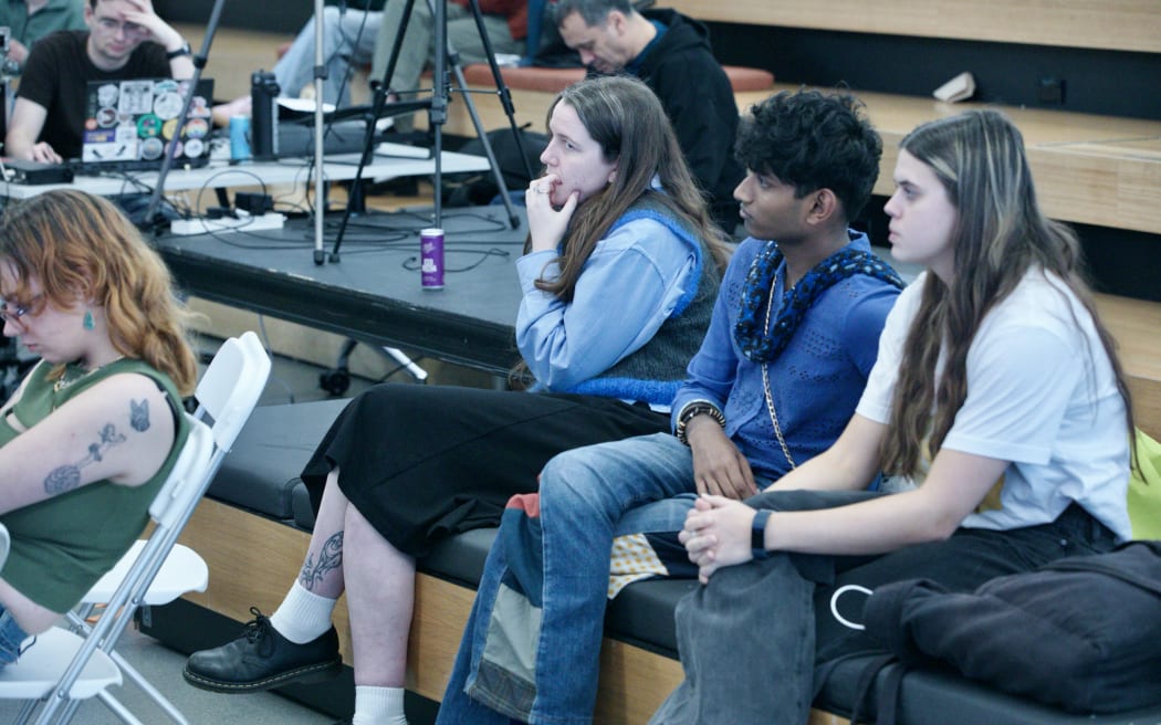 Electorate office staffer Lily watches on as Tamatha Paul answers questions from Victoria University students