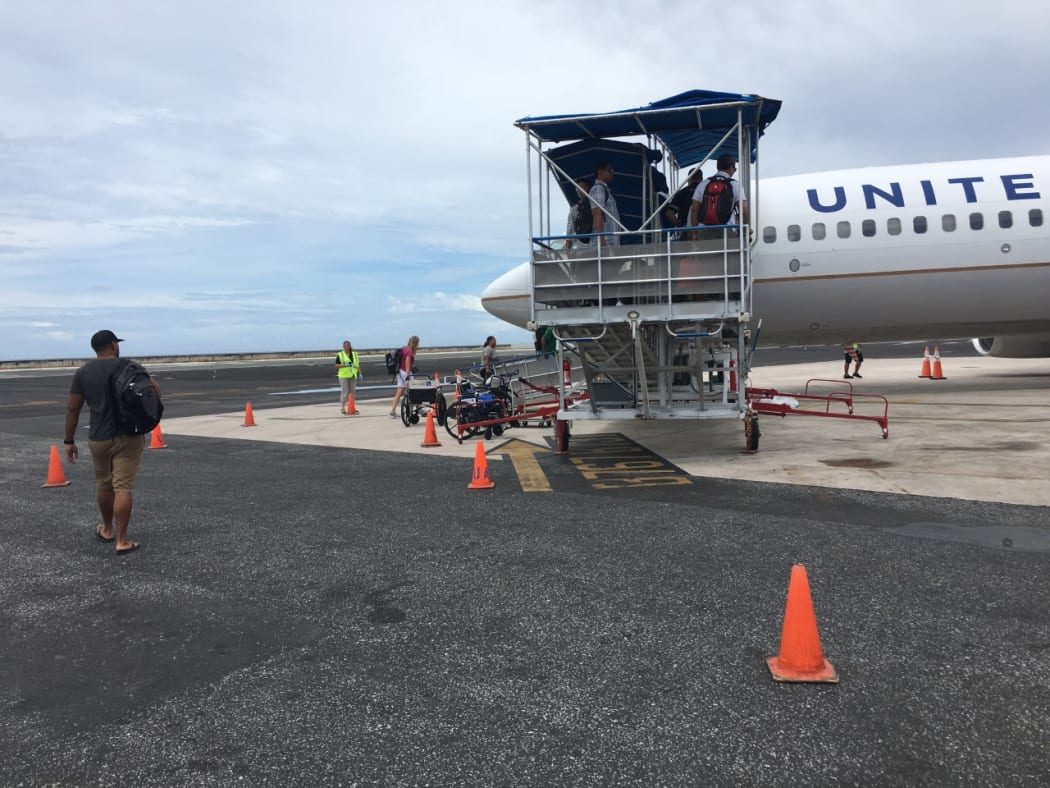 The Marshall Islands on Friday indefinitely banned all overseas travel by government employees and elected leaders in an effort to reduce opportunities for the importation of the new coronavirus. Pictured: Passengers boarding a United Airlines flight in Majuro.
