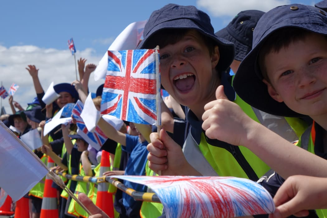 Fans of the royal couple wait to greet them at Mosgiel Railway Station.
