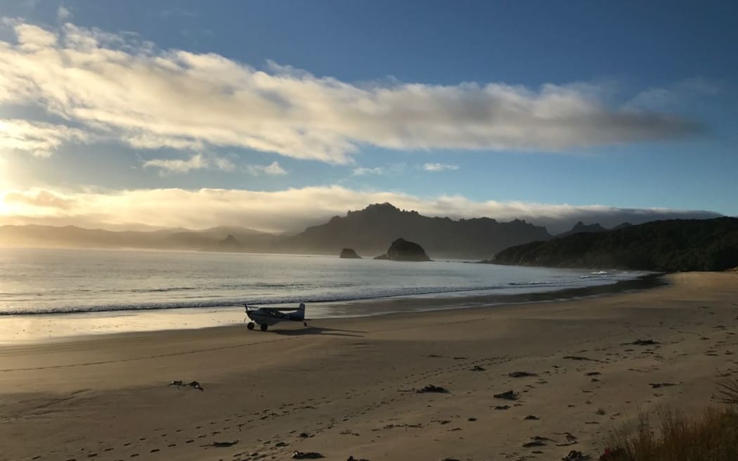 JEM the Cessna has been ferrying passengers and equipment for Whenua Hou / Codfish Island for 26 years. Stewart Island's Ruggedy Range is in the background.