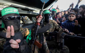 Hamas militants parade through Gaza after the ceasefire with Israel began on Sunday.