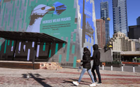 A sign in Federation Square urges people to wear a mask in the central business district in Melbourne on 6 August, 2020.