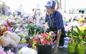 EL PASO, TX - AUGUST 16: Antonio Basco, who's wife Margie Reckard was one of 22 persons killed by a gunman at a local Walmart, lays flowers in her honor at a makeshift memorial near the scene on August 16, 2019 in El Paso, Texas.