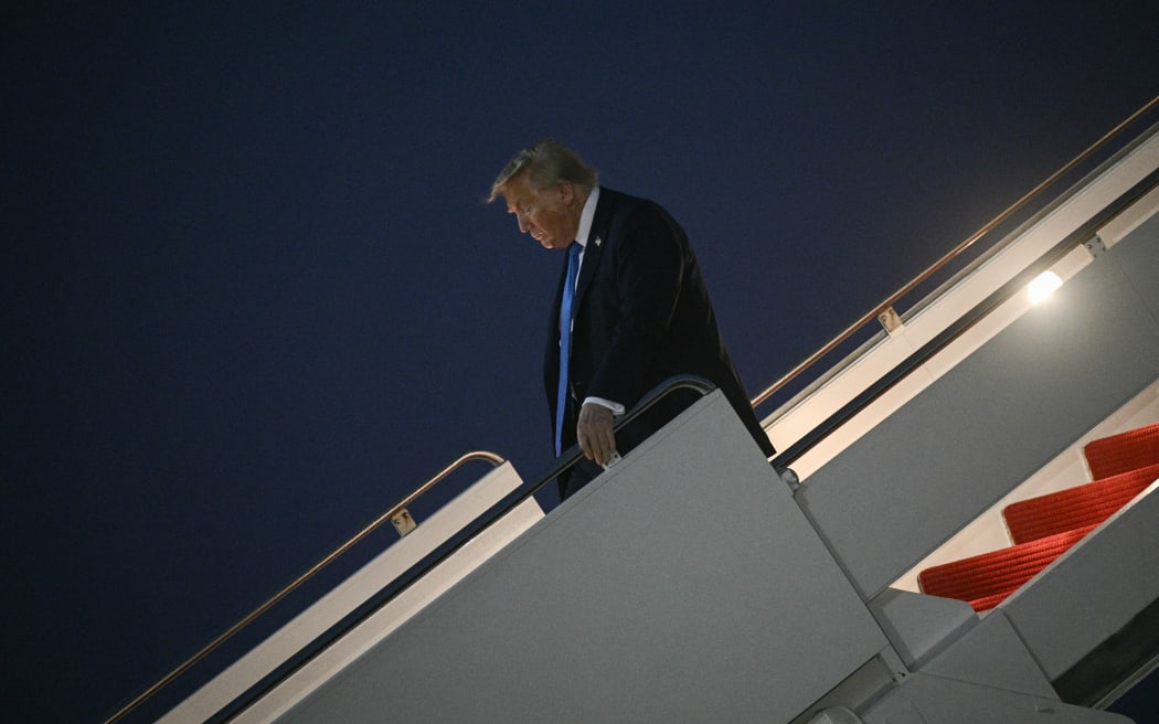 US President Donald Trump steps off Air Force One upon return to Joint Base Andrews in Maryland on June 17, 2025. US President Donald Trump left a Group of Seven summit early on June 16 as he hinted of greater involvement in the Israel-Iran conflict after issuing an ominous warning for the capital Tehran to evacuate. (Photo by Brendan SMIALOWSKI / AFP)