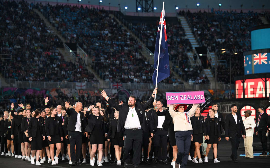 New Zealand's flag bearers Tom Walsh and Joelle King lead their country's athletes in the Parade of Nations during the opening ceremony for the Commonwealth Games at the Alexander Stadium in Birmingham, central England, on 28 July 2022.