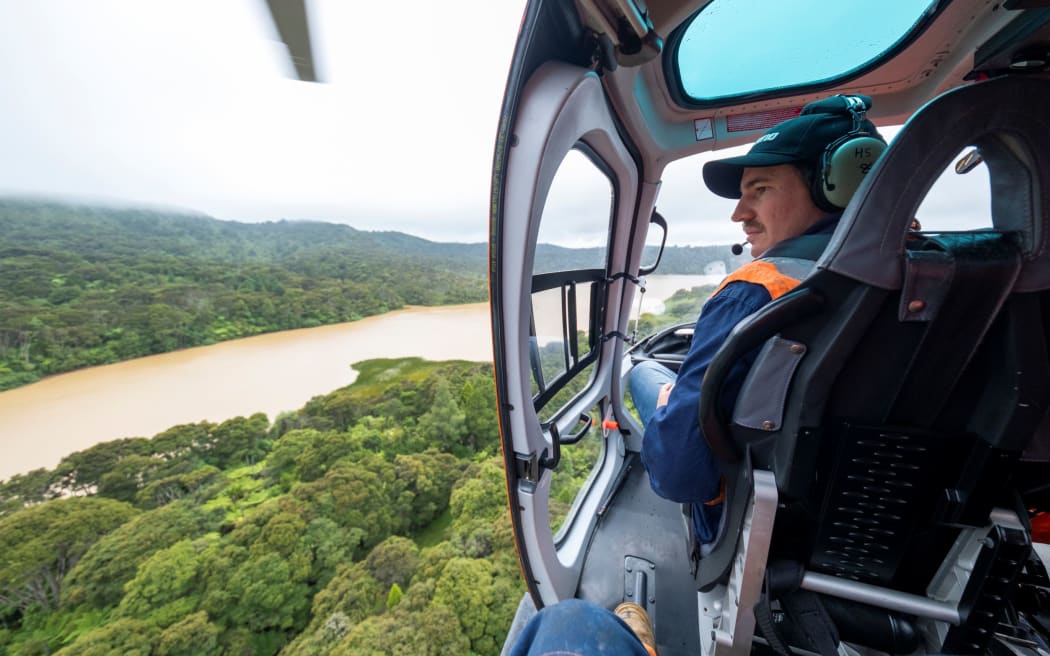 Watercare environmental assets manager James Talbot surveying the impact of the Auckland floods at the Lower Nihotupu Dam. 29 January, 2023