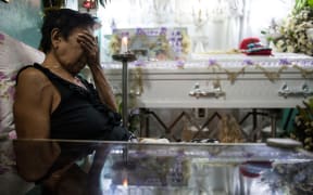 January 24, 2017: A relative at the wake of an alleged drug user killed by unidentified gunmen in Manila. Philippine police may have committed crimes against humanity by killing thousands of alleged drug offenders or paying others to murder as part of President Rodrigo Duterte's drug war.
