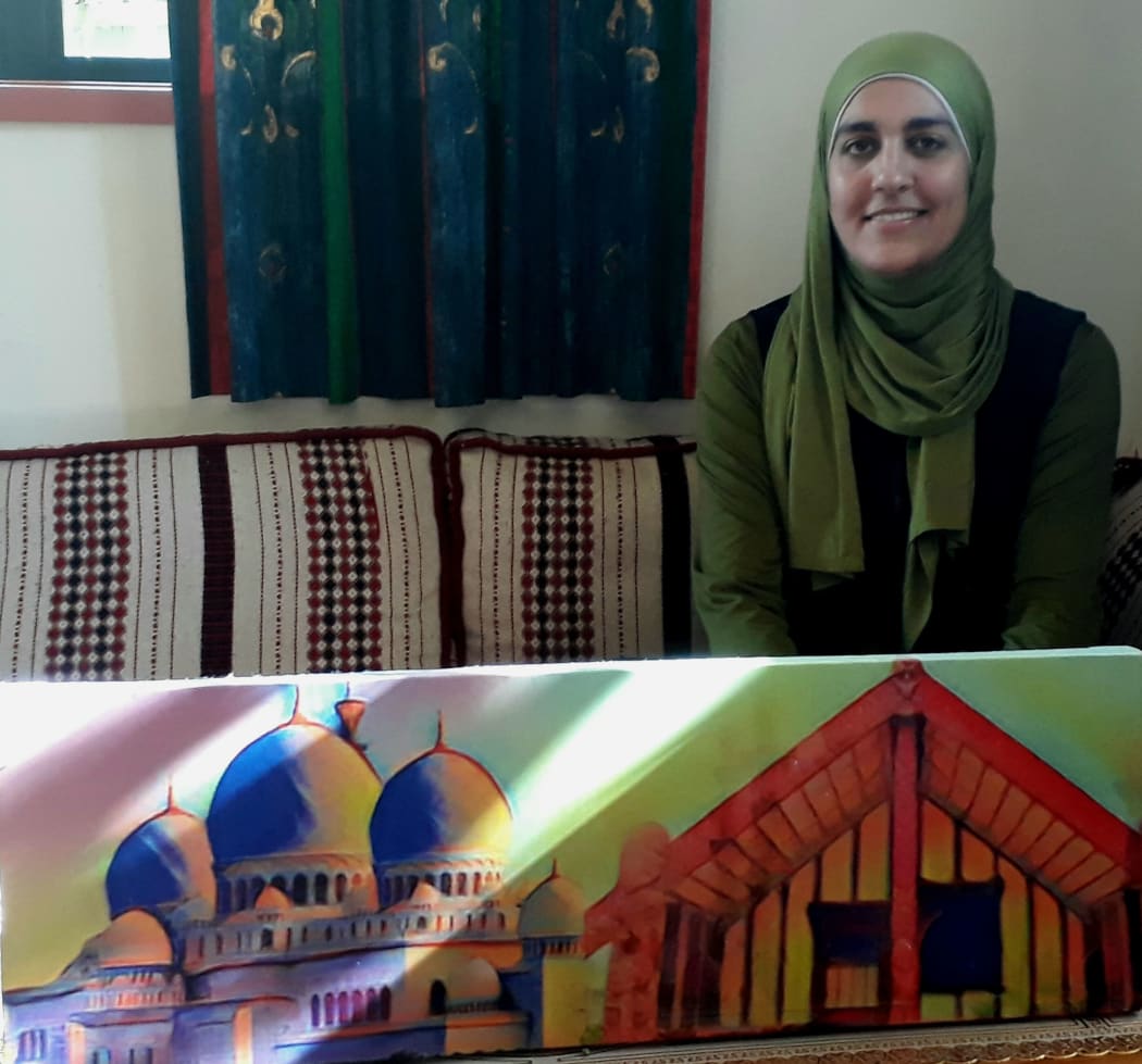 Mariam Arif at home and she shows how the artwork on the wall captures two cultures.