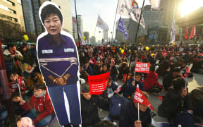 Protesters carry a portrait of South Korea's President Park Geun-Hye during a rally.