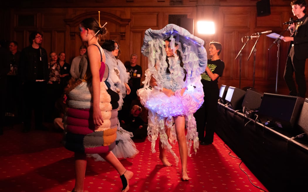 The Smokefree Rockquest brand has expanded to include other arts including film, photography, theatre and wearable arts. In this image a student wears a luminescent jellyfish costume.