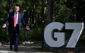 US President Donald Trump gestures during an arrival ceremony at the Group of Seven (G7) Summit at the Pomeroy Kananaskis Mountain Lodge in Kananaskis, Alberta, Canada on June 16, 2025. (Photo by Brendan SMIALOWSKI / AFP)