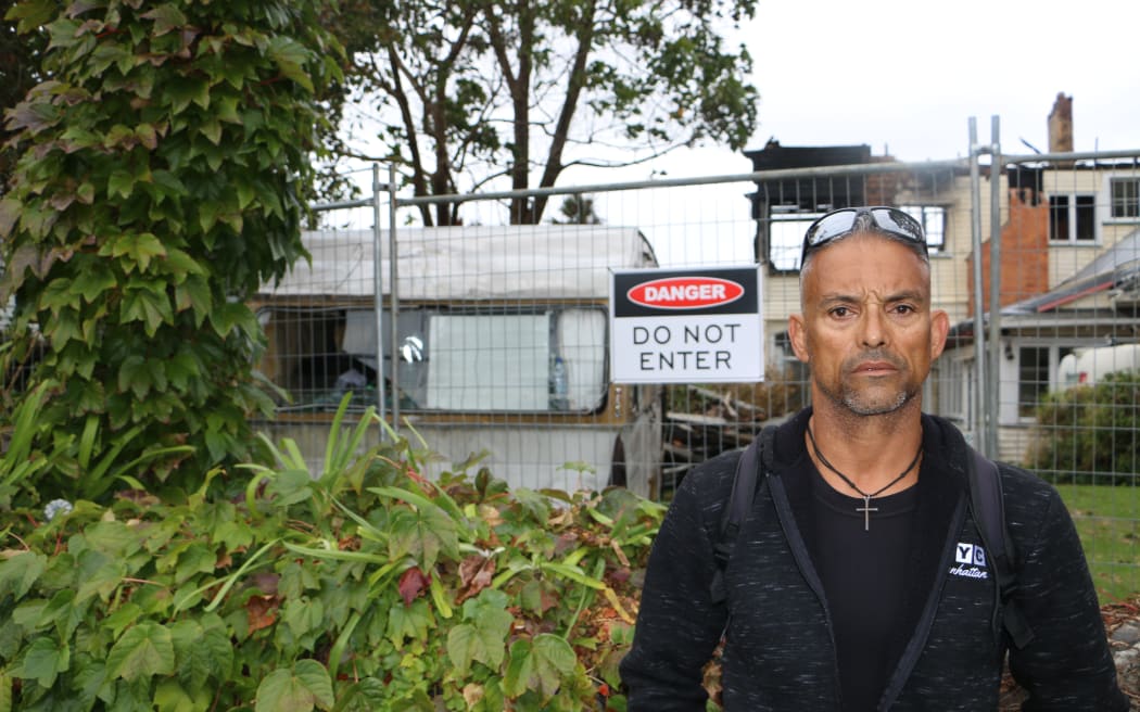 Ison da Silveira stands outside the site of the burnt City Garden Lodge, which caught ablaze on 7 April, 2024.