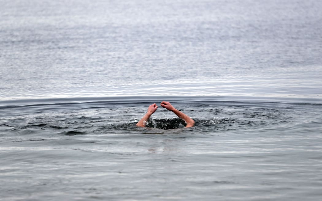 Church members dive into the three degrees Celsius cold water of Schwerin lake during the fifth Russian-Orthodox water sanctification in Schwerin, Germany, 19 January 2017. According to the Gregorian calendar, 19 January is the day of the baptism of Jesus. Photo: Jens Büttner/dpa-Zentralbild/dpa (Photo by JENS BUTTNER / DPA / dpa Picture-Alliance via AFP)