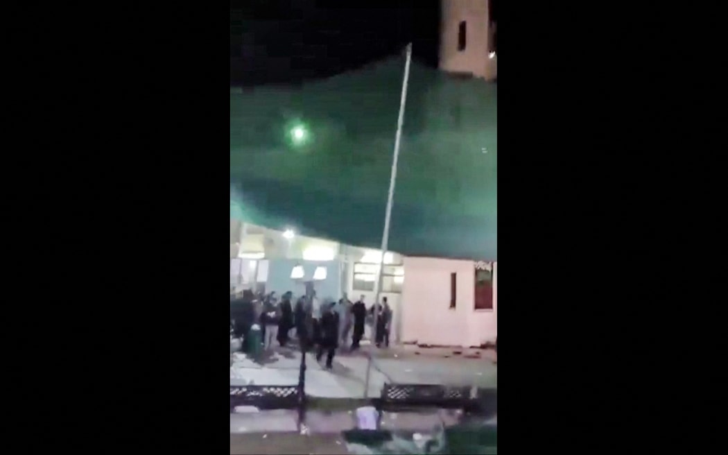 A still from a video of people fleeing the scene of a shooting at the Imam Ali Mosque in the Al-Wadi Al-Kabir area of Oman's capital Muscat, on 16 July, 2024.