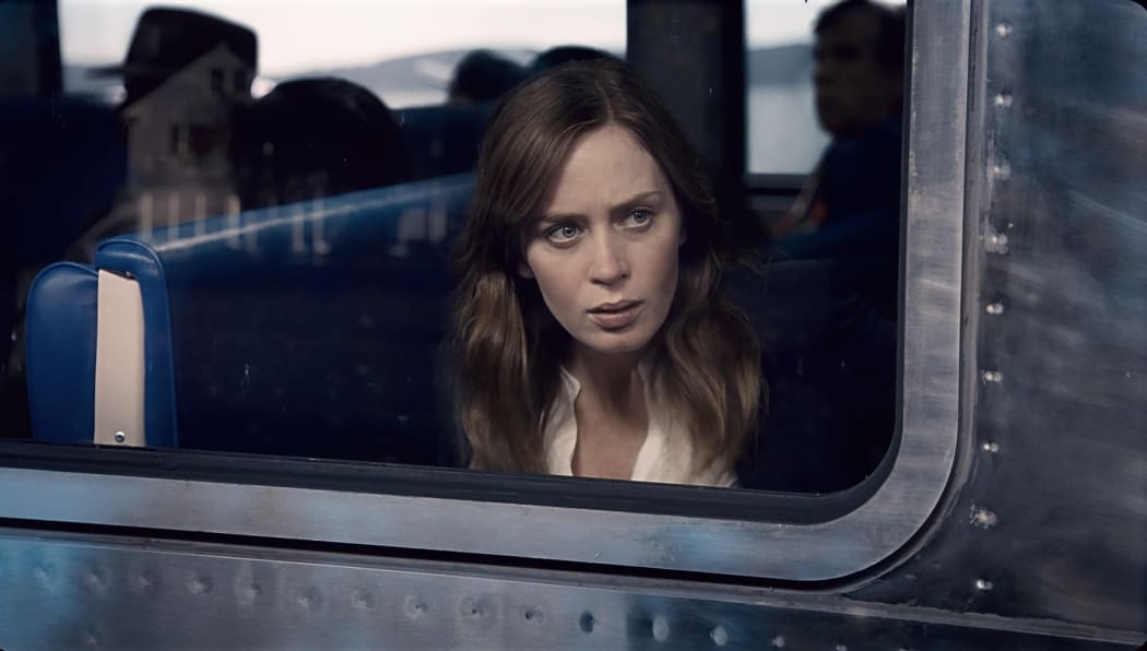 Emily Blunt looks out the train window