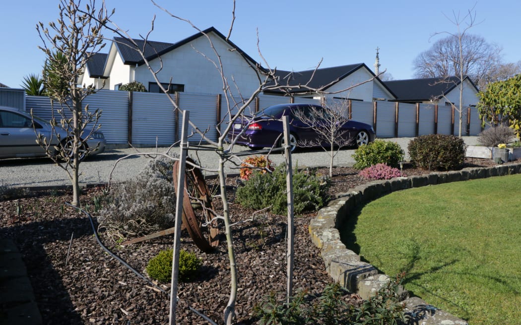 The couple who lived next door to the Dickason family have planted a memorial in their garden to remember the three girls who were killed.