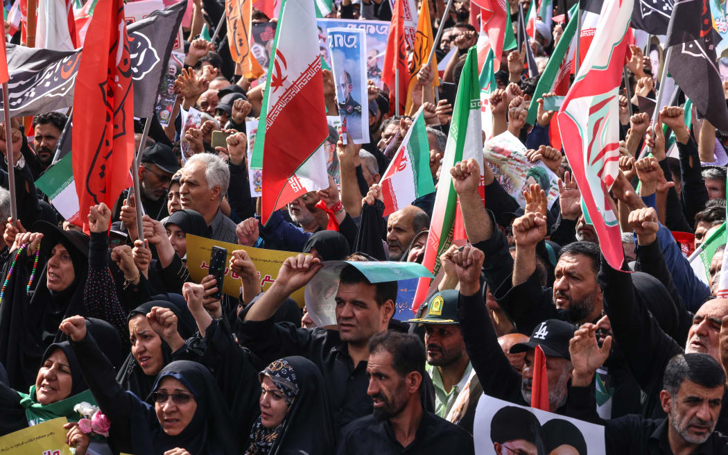 Mourners attend the funeral procession of Iranian military commanders and scientists killed during Israeli strikes at Enghelab (Revolution) Square in the capital Tehran on June 28, 2025. Iran began a state funeral service on June 28 for around 60 people, including its military commanders, killed in its war with Israel, after Tehran's top diplomat condemned Donald Trump's comments on supreme leader Ali Khamenei as "unacceptable". (Photo by ATTA KENARE / AFP)