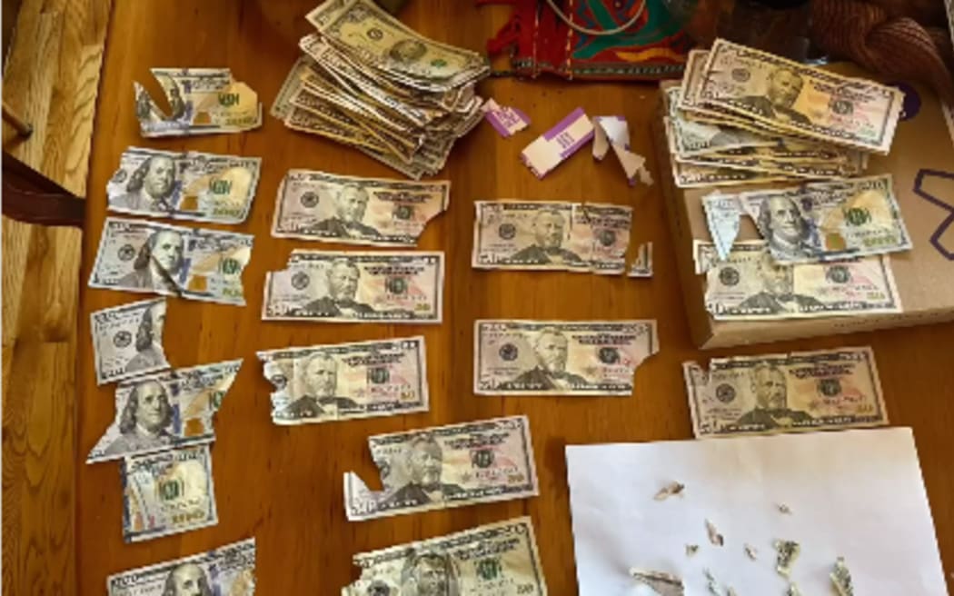 The Laws attempted to tape together the destroyed $50 and $100 bills bit by bit.