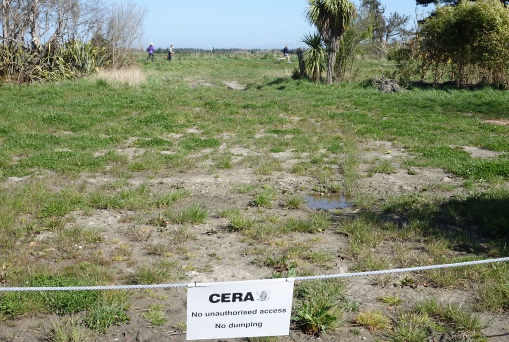 Children dash through a red zone property in Kairaki, north of Christchurch.