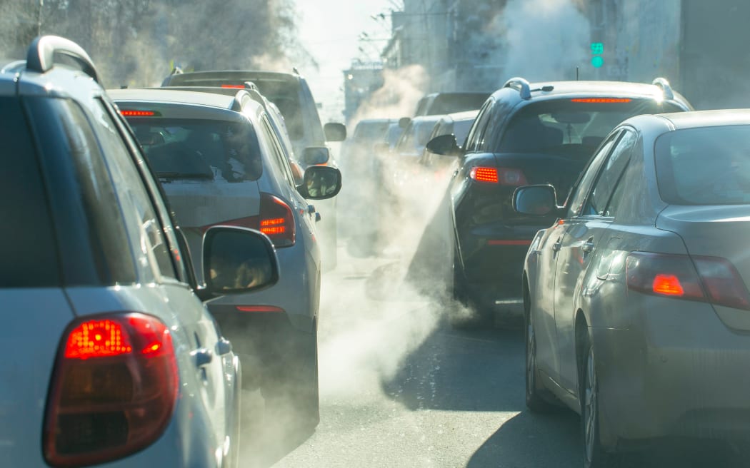 pollution from the exhaust of cars in the city in the winter. Smoke from cars on a cold winter day