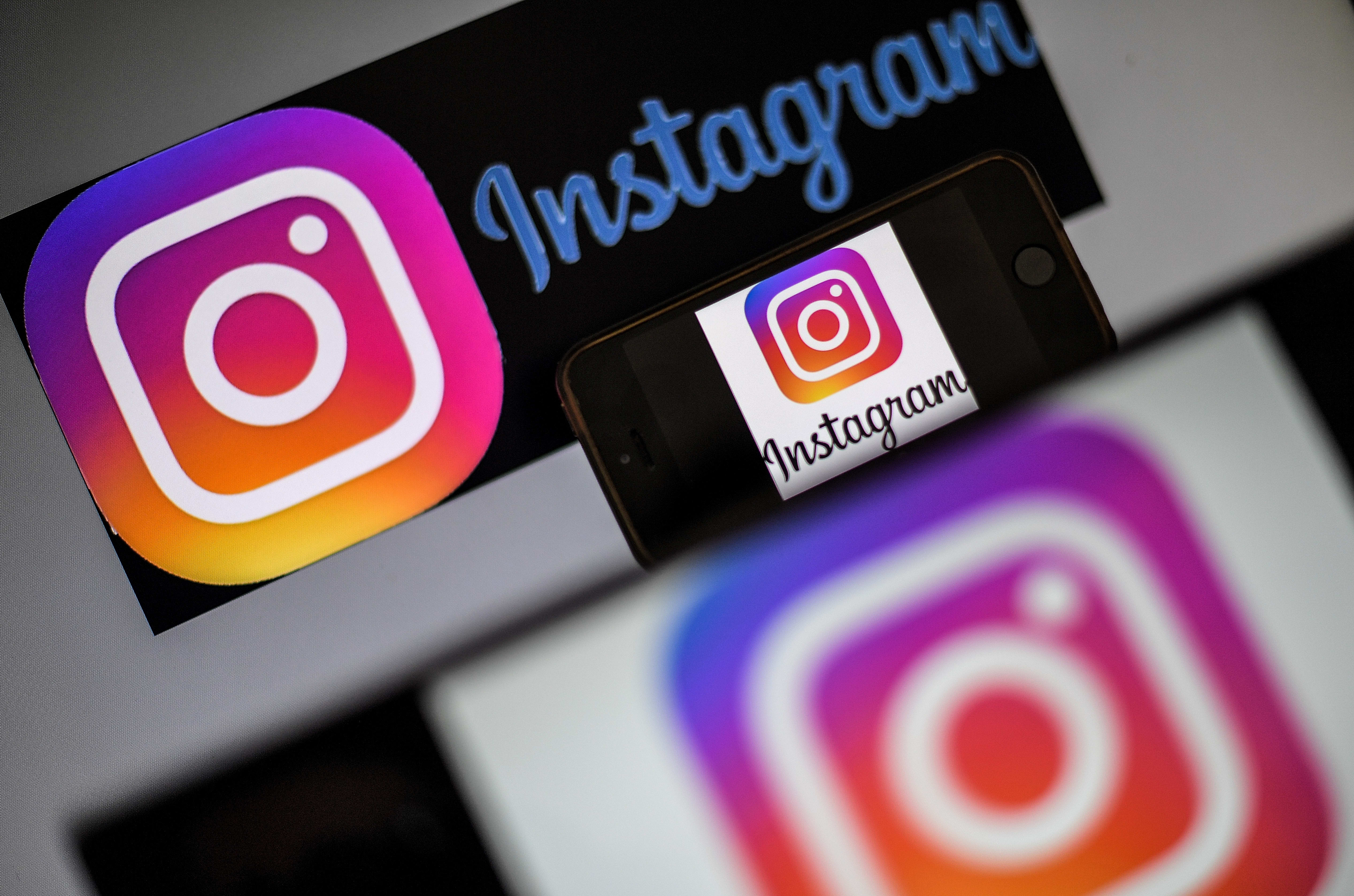 Logo of social network Instagram are displayed on the screen of a smartphone.