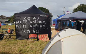 "I am the whenua, the whenua is me": Many campers have decorated their tents with whakataukī.