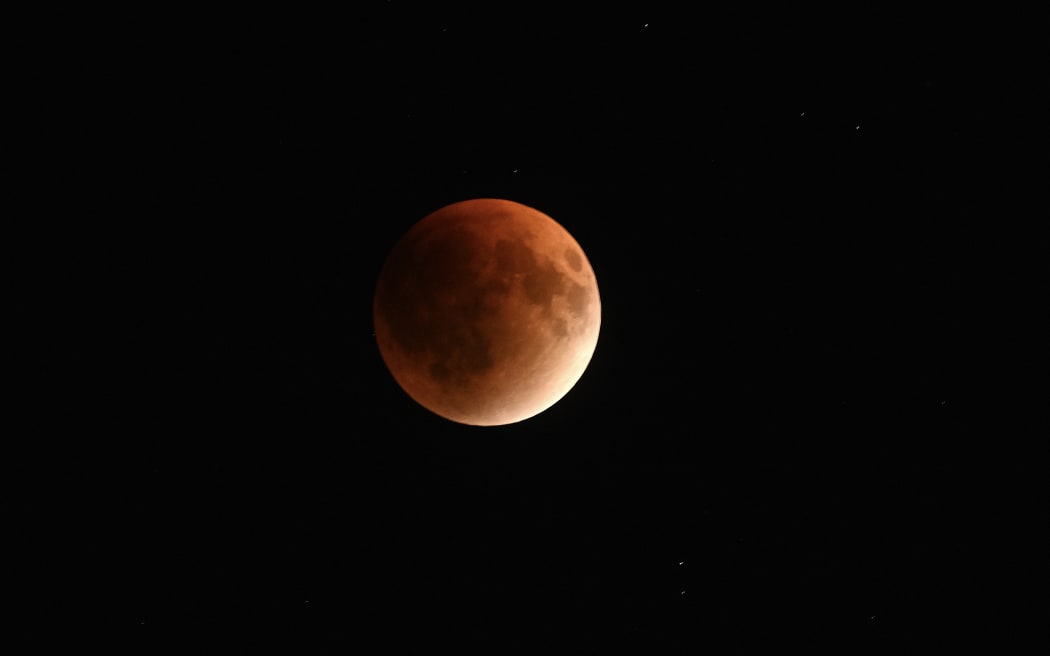 A full moon lunar eclipse also known as "Blood Moon" is seen over Islamabad, on September 7, 2025. Stargazers will have a chance to see a "Blood Moon" on Sunday night during a total lunar eclipse visible across Asia and swathes of Europe and Africa. (Photo by Aamir QURESHI / AFP)