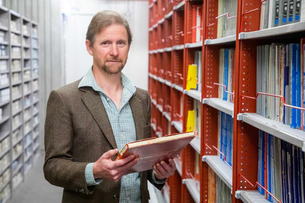Michael Brown, music curator at the Alexander Turnbull Library, among the music collection holdings at the National Library.
