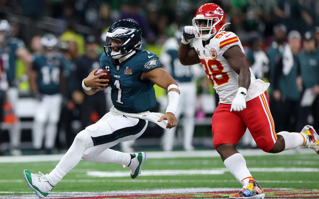 Jalen Hurts #1 of the Philadelphia Eagles is chased by Tershawn Wharton #98 of the Kansas City Chiefs in the third quarter during Super Bowl LIX at Caesars Superdome on February 09, 2025 in New Orleans, Louisiana.   Jamie Squire/Getty Images/AFP