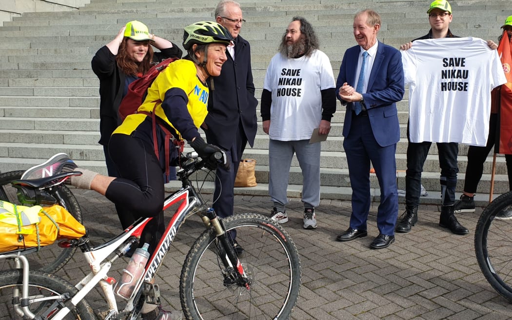 Katrina Marwick arrives at the steps of Parliament on her bike to deliver a petition against the proposed closure of the mental health facility to Nelson MP Nick Smith on 17 July, 2020.