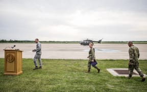 Travis Walters, Brigadier General Tracy Norris, and Col. Ronald Burket take the podium to address members of the media on April 6, 2018 in Austin, Texas.