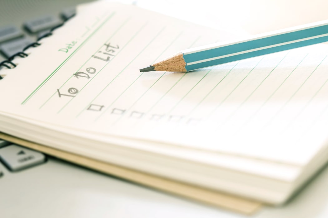 Handwritten to do list plan in a small note book. (File photo).