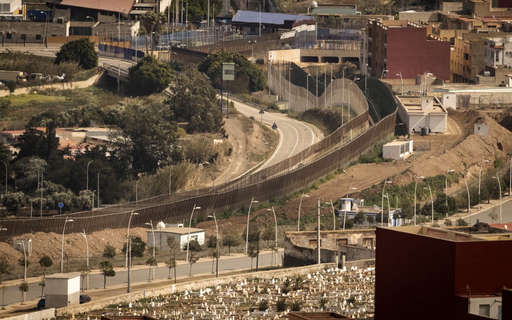 This file photo taken on 4 March, 2022 shows a view of the border fence separating Morocco (L) from Spain's North African Melilla enclave (R), near Nador in Morocco. Around 2000 migrants tried to storm the border separating Spain's Melilla enclave from Morocco on 24 June, the first such attempted mass crossing into the territory since the two nations mended diplomatic ties in March. Over 500 managed to enter the border control area after cutting a fence with shears, the Spanish government's local delegation said in a statement.