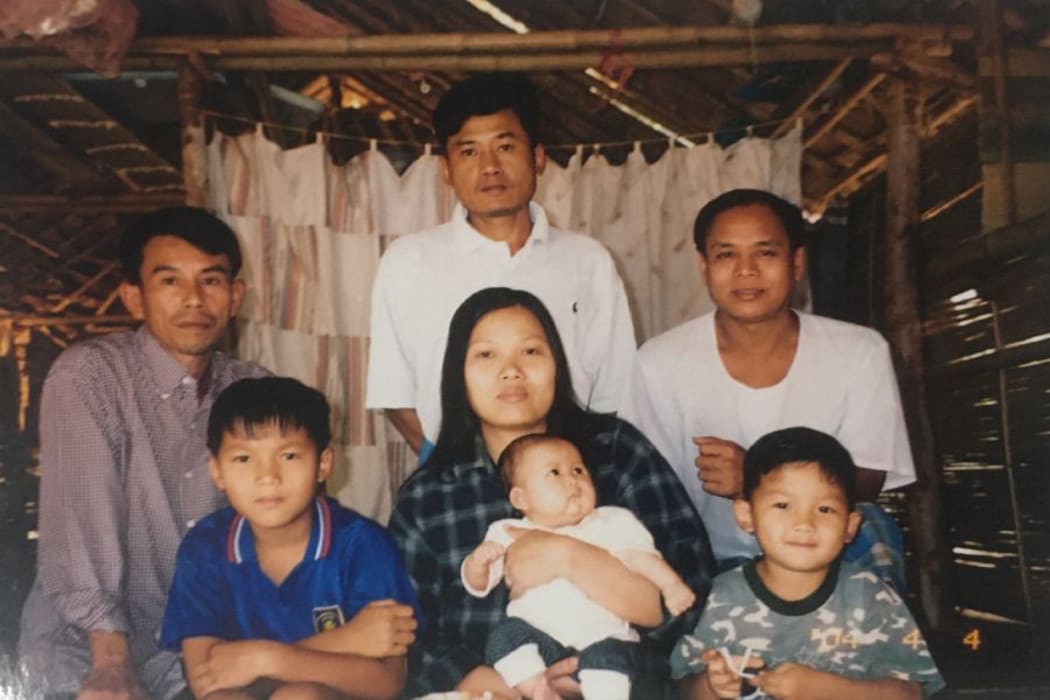 Myint San Aung (lower, L) and his family in the camp