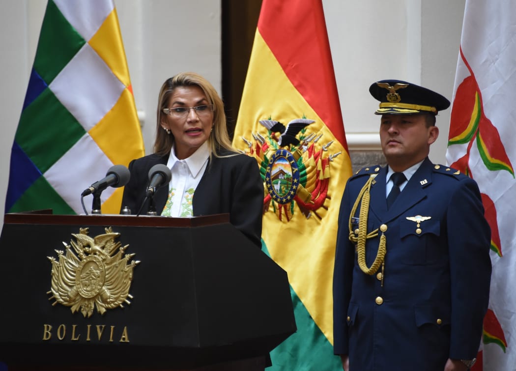 Bolivia's interim president Jeanine Anez skpeaks after signing off on new elections excluding ex-president Evo Morales, in a key step towards ending weeks of unrest as the caretaker government prepared to meet with protesters to end weeks of unrest, in La Paz on November 24, 2019.