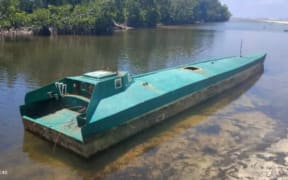 The narco sub after it was towed, for four hours, from open water back to Reubenson and Martin Fugui's village.   (Supplied)